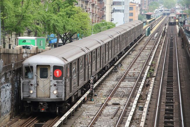 Subway car pulling into aboveground station