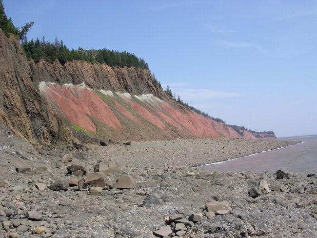 Photo of black, white and red rock cliffs