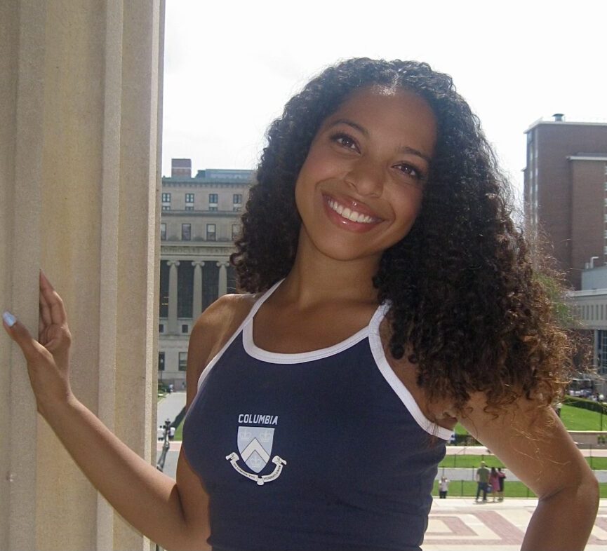 Woman smiling in tank top on campus