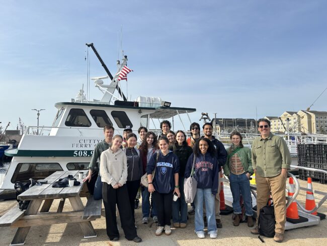 Students in front of a boat