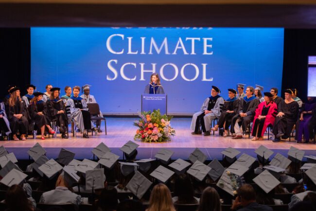 Dean speaks on stage to graduates