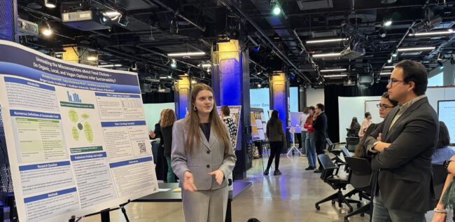 Woman giving poster presentation