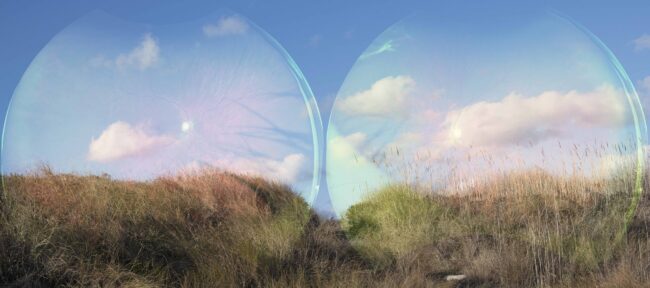 Photograph with two lenses over grass and sky