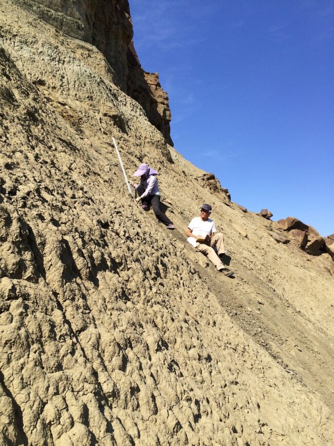 Yanan Fang and Paul Olsen on the slope of the Sangonghe Formation in northwestern China.