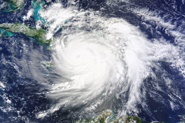 Image of spiral cloud formation swirling over the ocean and islands.