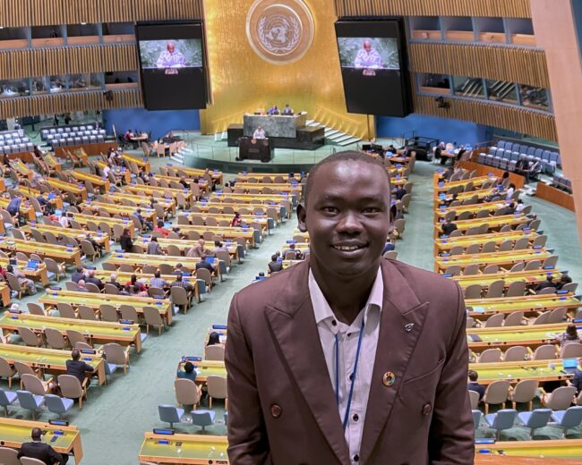 Anyieth Philip Ayuen stands in a conference room